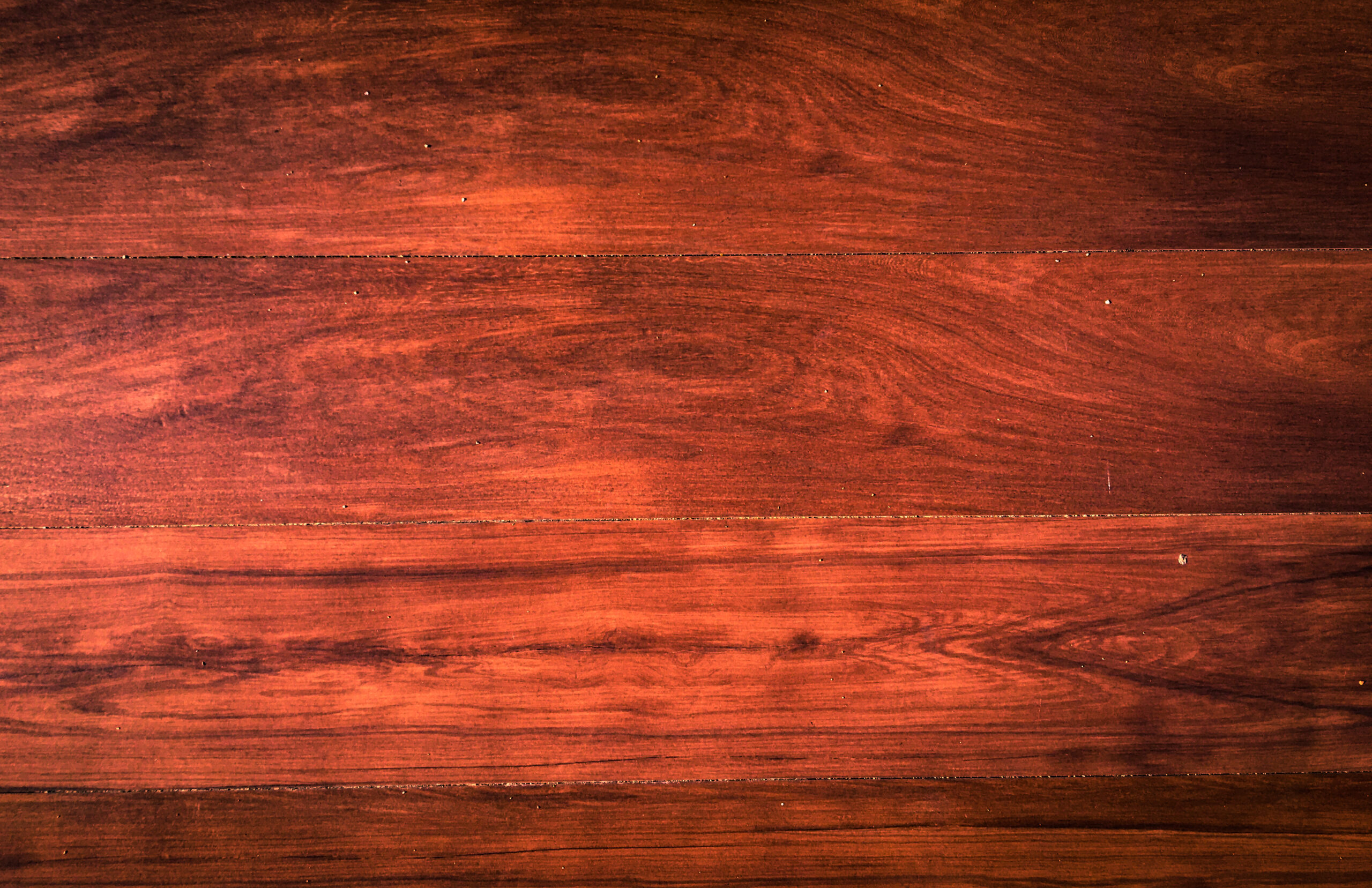Rich brown Genuine Mahogany wood surface showcasing its straight to interlocked grain, ideal for high-quality